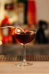 Red alcoholic cocktail on the bar counter