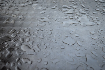 Close up view of water rain drops on a metal surface	