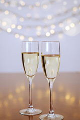 Two glasses of wine with bokeh background close up. Top view. New Year, Christmas mood. Greeting card. Party and holiday celebration concept.