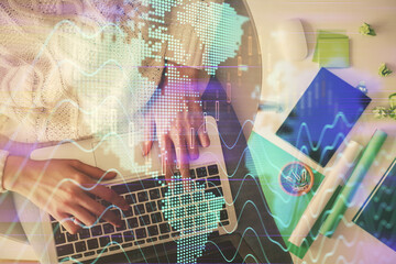 Multi exposure of woman hands working on computer and forex chart hologram drawing. Top View. Financial analysis concept.