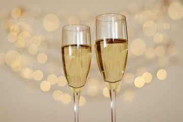 Two glasses of wine with bokeh background close up. Top view. New Year, Christmas mood. Greeting card. Party and holiday celebration concept.