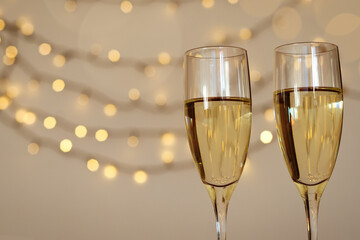 Two glasses of wine with bokeh background close up. Top view. New Year, Christmas mood. Greeting card. Party and holiday celebration concept.
