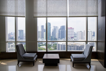 Fototapeta premium Glass windows in the office building, panoramic city view and daylight.