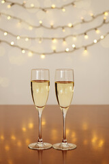 Two glasses of wine with bokeh background close up. Top view. New Year, Christmas mood. Greeting card. Party and holiday celebration concept.