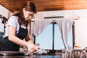 Woman prepares to make a cake.  Housewife in the kitchen.