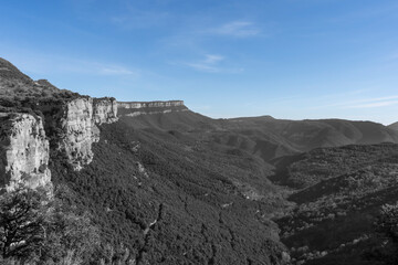 Amazing mountain landscape, picturesque forest , rural scenery near Rupit in Spain.Holidays in countryside concept.Creative selective color effect, blue sky in black and white photography style.