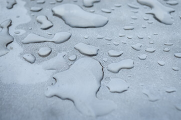 Close up view of water rain drops on a metal surface