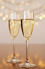 Two glasses of wine with bokeh background close up. Top view. New Year, Christmas mood. Greeting card. Party and holiday celebration concept.