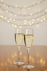 Two glasses of wine with bokeh background close up. Top view. New Year, Christmas mood. Greeting card. Party and holiday celebration concept.
