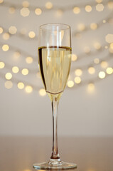 Glass of wine with bokeh background close up. Flat lay. New Year, Christmas mood. Greeting card. Party and holiday celebration concept.