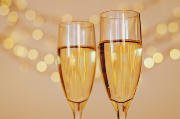 Two glasses of wine with bokeh background close up. Top view. New Year, Christmas mood. Greeting card. Party and holiday celebration concept.