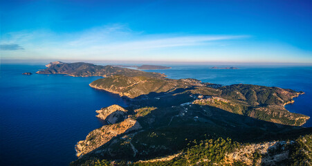 Fototapeta na wymiar Aerial drone view over western Alonnisos towards Skopelos island at sunset. Natural landscape, beautiful rocky scenery, spectacular view in Sporades, Aegean sea, Greece
