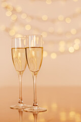 Two glasses of wine with bokeh background close up. Top view. New Year, Christmas mood. Greeting card. Party and holiday celebration concept.
