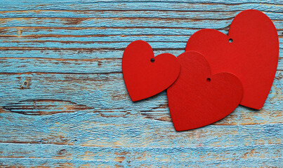 Valentine's day background. three red hearts on blue wooden background, Love, wedding day, mother's day, concept. love symbol. family symbol. with place for text
