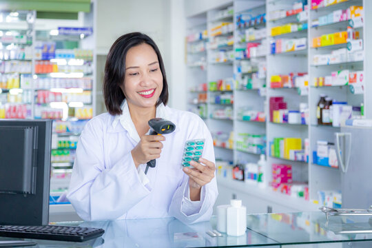 Pharmacist scanning barcode of medicine drug in a pharmacy drugstore. Health care and medical concept.