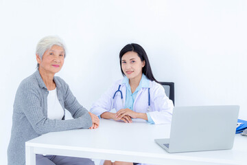 Female doctor consulting with senior patient at clinic. Healthcare, medical, treatment and elderly diseases concept.