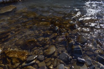 River shore full of rocks underwater. 
