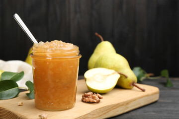 Delicious pear jam and fresh fruits on black table. Space for text