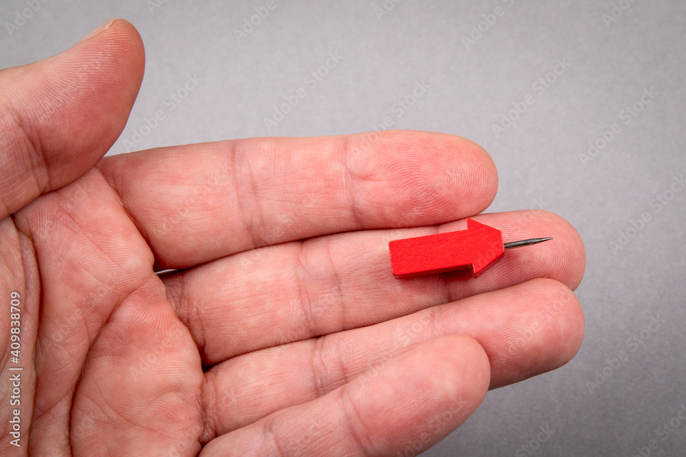 Canvas Prints red arrow on a man's palm. gray background