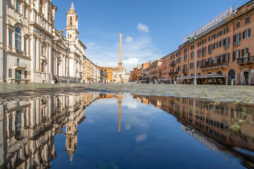 Fototapeta na wymiar Rome, Italy - in Winter time, frequent rain showers create pools in which the wonderful Old Town of Rome reflect like in a mirror. Here in particular Piazza Navona