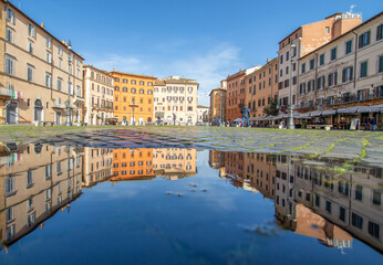 Obraz premium Rome, Italy - in Winter time, frequent rain showers create pools in which the wonderful Old Town of Rome reflect like in a mirror. Here in particular Piazza Navona