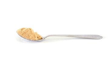 ginger powder in a spoon on a white