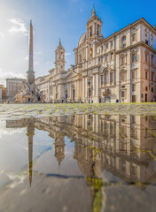 Obraz premium Rome, Italy - in Winter time, frequent rain showers create pools in which the wonderful Old Town of Rome reflect like in a mirror. Here in particular Piazza Navona