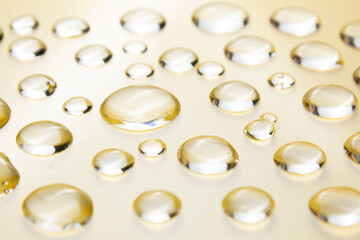 Gel drops on yellow background. Virus protection or cosmetics concept texture