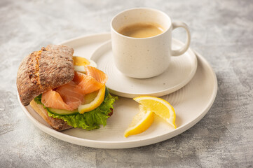 Sandwiches with smoked salmon, salad, cucumbers and eggs.