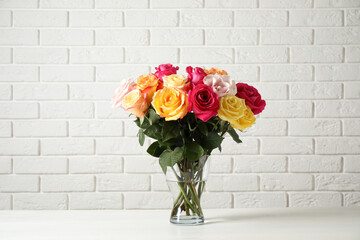 Luxury bouquet of fresh roses on white table