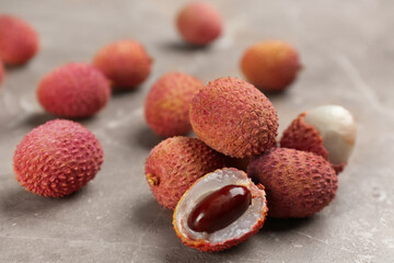 Fresh ripe lychee fruits on grey table
