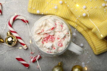Flat lay composition with delicious marshmallow drink, festive decor and yellow sweater on light grey table