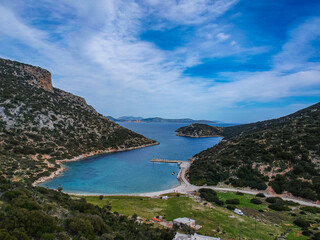 Fototapeta premium Aerial panoramic view of the picturesque old harbor Gerakas in northern Alonnisos, Greece. Beautiful scenery with rocky formation and natural fjord-like bay in Sporades Aegean sea, Greece