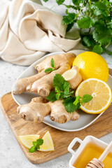 Ingredients for ginger tea with lemon, honey and mint. Lemon, ginger, honey and lemon balm on the table. Healthy food to boost immunity. Ingredients for ginger cookies with honey and mint