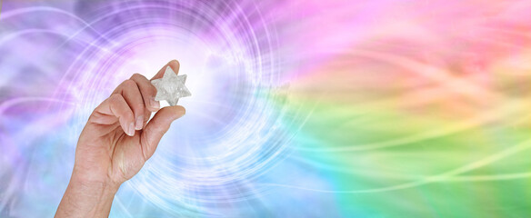 The incredible energy a Merkabah emits - male hand holding a white quartz Merkabah polished crystal...