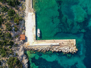 Aerial panoramic view of the picturesque old harbor Gerakas in northern Alonnisos, Greece. Beautiful scenery with rocky formation and natural fjord-like bay in Sporades Aegean sea, Greece