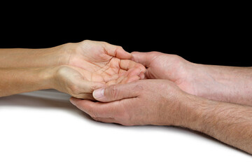 Fototapeta premium Male Reiki teacher sensing female student's energy - male hands cupped around female cupped hands against a black background with copy space 