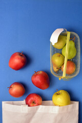 Detail of fruit purchased in plastic packaging and in reusable fabric bags