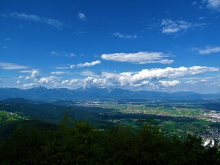 Scenic view of Gorenjska region of Slovenia with the town of Kranj and othe villages and agricultural land and forests and Kamnik-Savinja alps