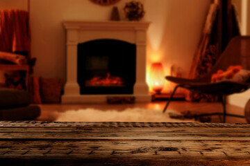 Empty wooden surface and blurred view of fireplace in room