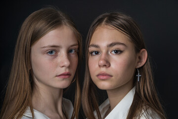 Portrait of two beautiful young girls, close up