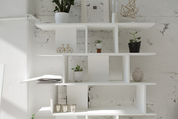 Spacious stylish modern trendy loft apartment in white and light colors. brick wall, wood floor, shelving, pallet bed and teepee-shaped children's house. everything is white with gray tints.