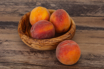 Peach heap in the wooden basket