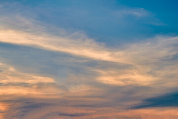 Summer evening sky in the picturesque clouds, lit by the rays of the setting sun.