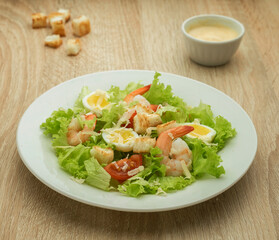 Caesar salad with shrimps and quail eggs