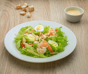 Caesar salad with shrimps and quail eggs
