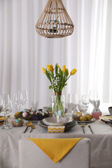 Beautiful Easter table setting with festive decor indoors