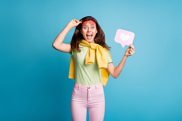 Photo of impressed funny person open mouth good mood hold heart paper pink glasses isolated on blue color background