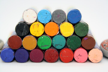 Colorful crayons for painting on a white background.