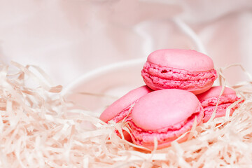 French pink macaroon cookies on silk tablecloth
